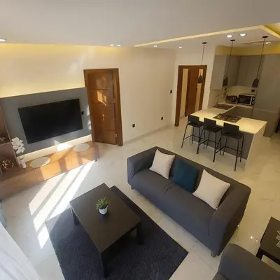 a living room with a couch and a table at Central Amman Twin Towers Apartment 2 in Amman