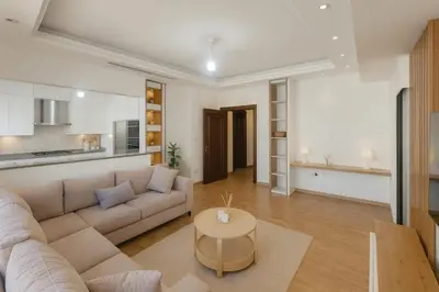 a living room with a couch and a table at Prime City Luxury Apartment in Amman