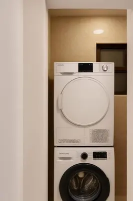 a washing machine and a washer in a room at Prime City Luxury Apartment in Amman