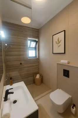 a bathroom with a sink and a toilet at Prime City Luxury Apartment in Amman