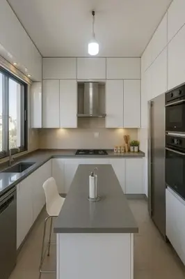 a kitchen with white cabinets and a counter top at Prime City Luxury Apartment in Amman