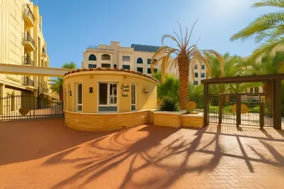 a small house on a balcony with palm trees at Elite Apartment Compound in Amman