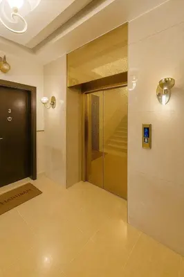 a hallway with a glass door and a staircase at Elite Apartment Compound in Amman