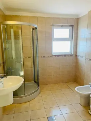 a bathroom with a shower and a sink at Furnished Villa in Andalusian Compound for Rent in Madaba