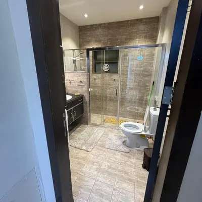 a bathroom with a shower and a toilet at عبدون الشمالي -بالقرب من السفارة البريطانية in Amman