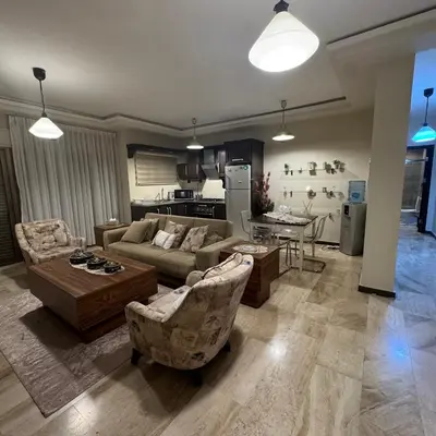 a living room with a couch and chairs and a table at عبدون الشمالي -بالقرب من السفارة البريطانية in Amman