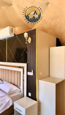 a bedroom with a bed and a sign on the ceiling at WADI RUM BUBBlE AOSE CAMP in Wadi Rum