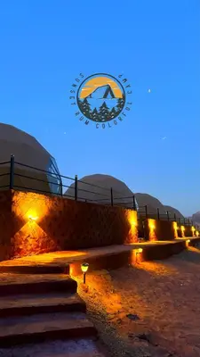 a building with a sign on the side of it at WADI RUM BUBBlE AOSE CAMP in Wadi Rum