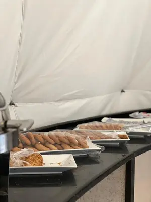 a table topped with trays of bread and pastries at RUM NADINE LUXURY CAMP & Bubbles Hotel in Wadi Rum
