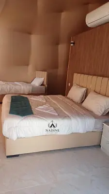 a bedroom with two beds in a room with at RUM NADINE LUXURY CAMP & Bubbles Hotel in Wadi Rum