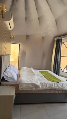 a small bed in a room with a window at RUM NADINE LUXURY CAMP & Bubbles Hotel in Wadi Rum
