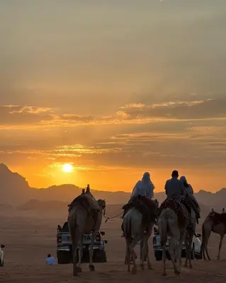 a group of people riding horses in the desert at Desert soul in Wadi Rum
