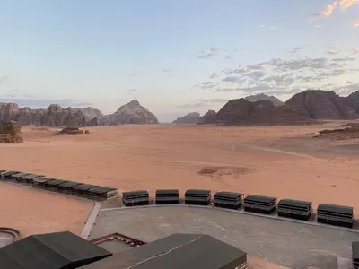a view of a desert with some chairs and mountains at Desert soul in Wadi Rum