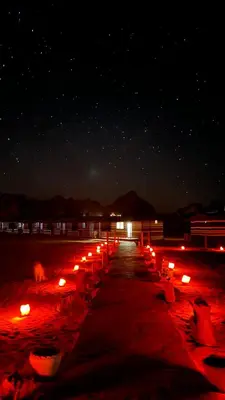 a row of candles on a beach at night at Desert soul in Wadi Rum