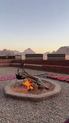 a fire pit with a stick on top of it at Desert soul in Wadi Rum