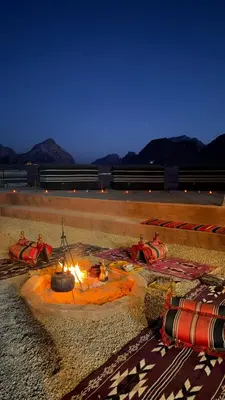 a fire pit in the middle of a road at night at Desert soul in Wadi Rum