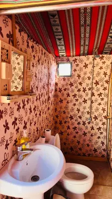 a bathroom with a sink and a toilet at Desert Nights camp in Wadi Rum