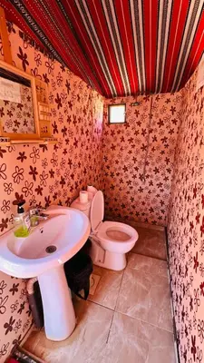 a bathroom with a sink and a toilet at Desert Nights camp in Wadi Rum