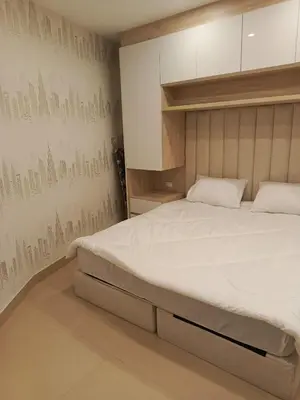 a bedroom with a large bed and a wall mural at Al yaqoot apartment in Amman