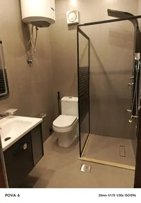 a bathroom with a shower with a toilet and a sink at Al yaqoot apartment in Amman