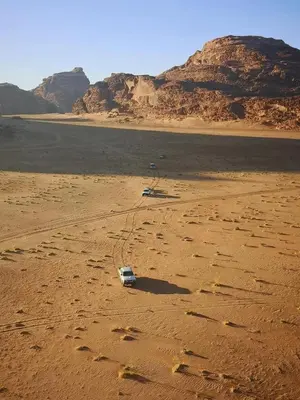 a car sitting in the sand in the desert at ELENA lUXURY CAMP in Wadi Rum