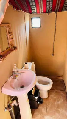 a small bathroom with a sink and a toilet at Desert Nights camp in Aqaba