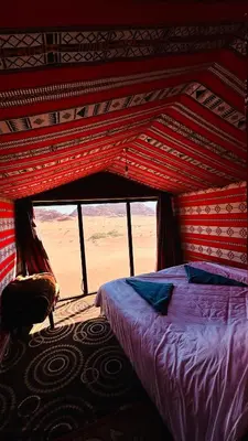 a bedroom with a bed in a tent at Desert Nights camp in Wadi Rum