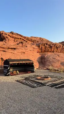 a building in front of a red cliff at Desert Nights camp in Wadi Rum