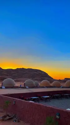 a group of domes in the desert at sunset at عماد رم in Wadi Rum