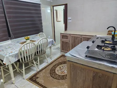 a kitchen with a table and chairs and a stove at small house in Amman