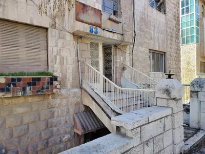 a stone building with stairs in front of a building at small house in Amman