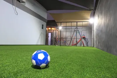 a blue and white soccer ball on the grass in a gym at Bellagio Chaleht in Al Rama