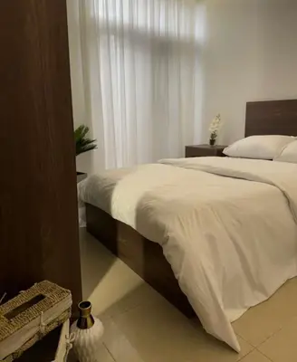 a bedroom with a large bed and a window at شقة lvaisa الفندقيه in Umm Uthainah