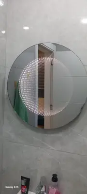 a large circular mirror in a room with a table at غزو 15 in Aydūn