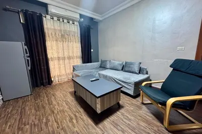 a living room with a couch and a chair at Central Budget Stay in Amman