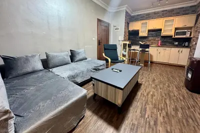 a living room with a couch and a table at Central Budget Stay in Amman