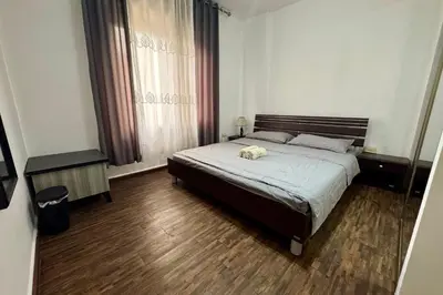 a bedroom with a bed with a towel on it at Central Budget Stay in Amman