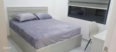 a bed with two pillows and a window in a room at غزو 15 in Aydūn