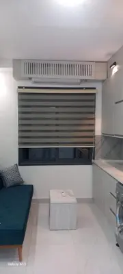 a living room with a blue couch in a kitchen at غزو 15 in Aydūn
