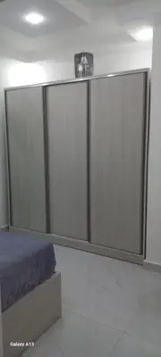 a bedroom with sliding glass doors and a bed at غزو 15 in Aydūn