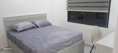 a bed with two pillows and a window in a room at غزو 15 in Aydūn