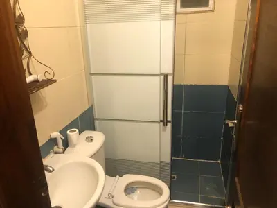 a small bathroom with a toilet and a sink at Irbid in Irbid