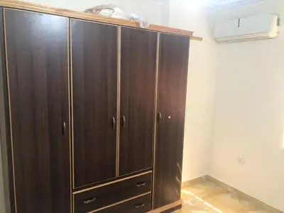 a large wooden cabinet in a room at Irbid in Irbid