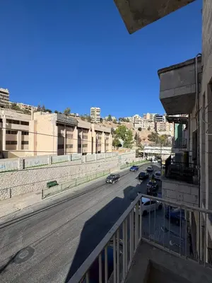 a view of a city street with cars on the road at Cozy Studio in a Creative Hub in Amman