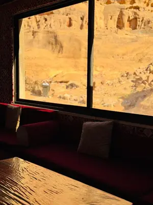 a room with a view of the desert from a window at Rum Dreamland luxury camp in Wadi Rum