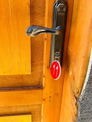 a wooden door with a door knocker on it at Rum Dreamland luxury camp in Wadi Rum