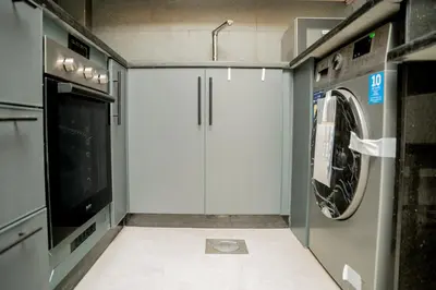 a washer and dryer in a kitchen with a washing machine at Maria Suites 2 in Aqaba