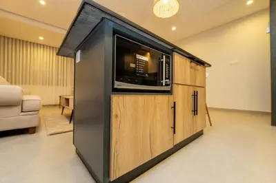 a building with a tv in a living room at Maria Suites 1 in Aqaba