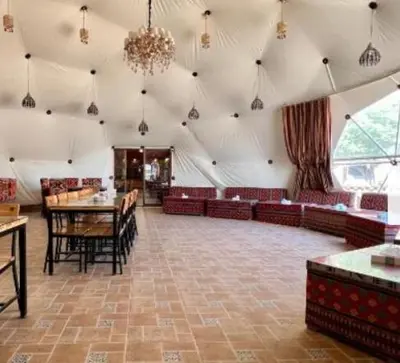 a large room with tables and chairs and a chandelier at Wadi Rum, the best stars in Wadi Rum