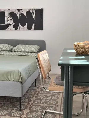 a bedroom with a bed and a desk and a table at Turath by Badiya 2BR Apt In Luweibdeh in Amman